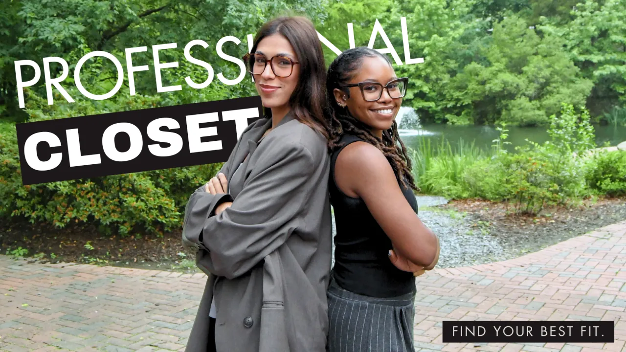 Sara and Jasmine of the UNC Charlotte SECU internship program pose back-to-back while smiling in their professional clothing.