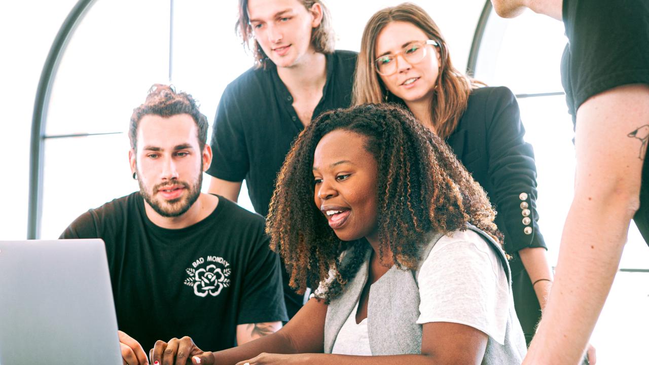 Group of people looking at computer