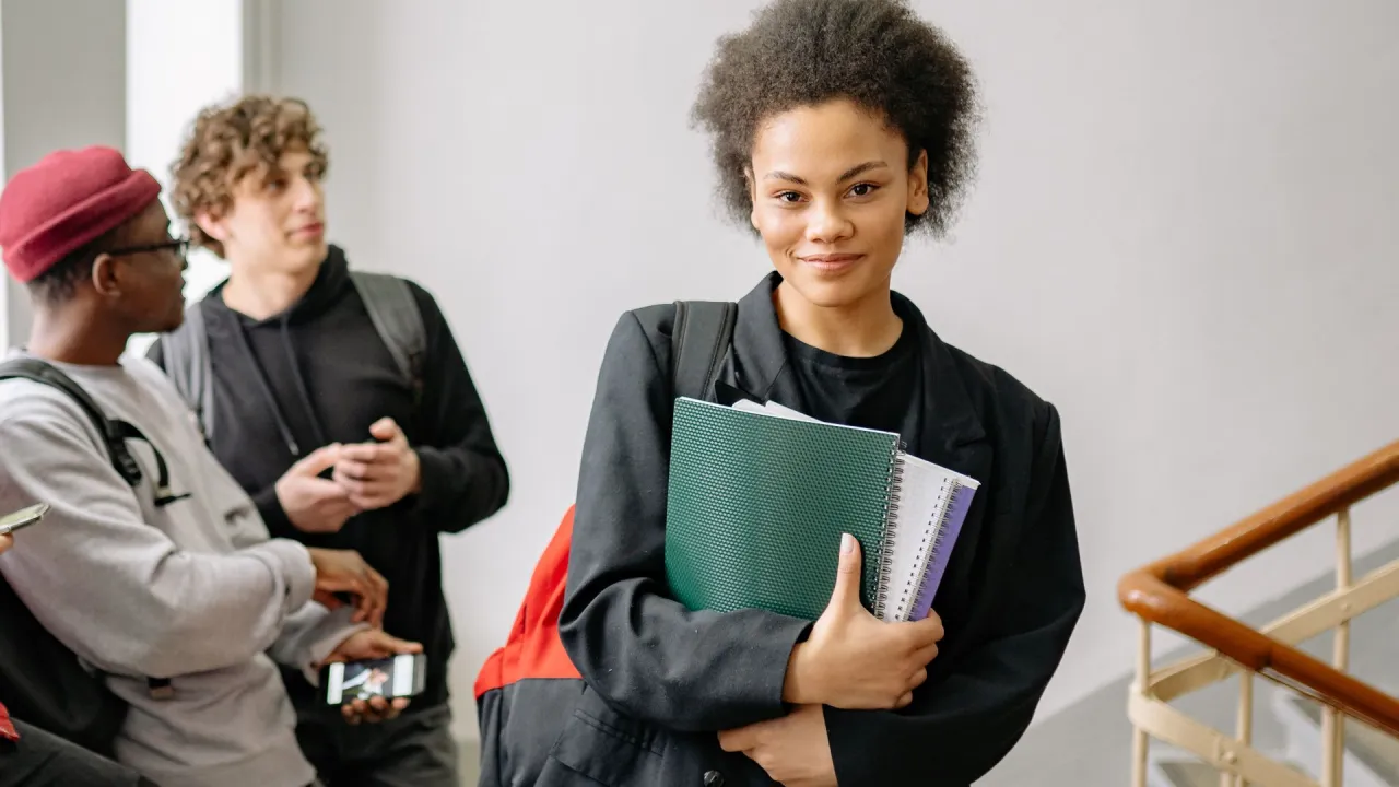 3 students in a hallway