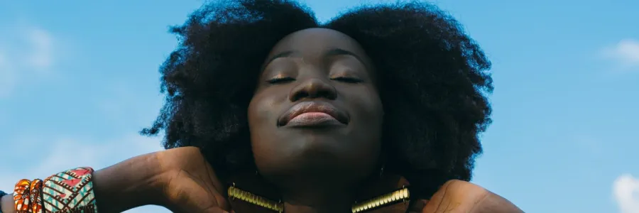 Black Women smiling with Blue Sky background