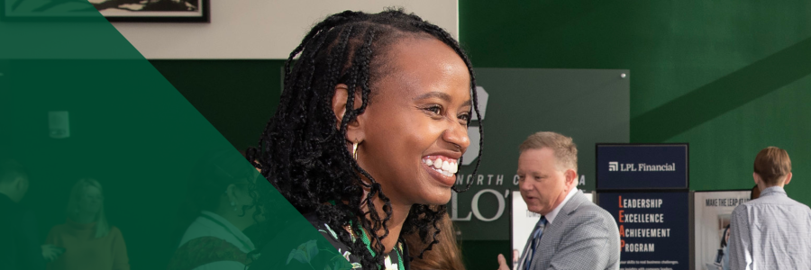 Student smiles brightly at a career fair at unc charlotte dubois center