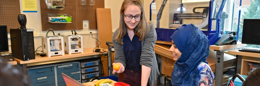 Two people are working in the unc charlotte makerspace