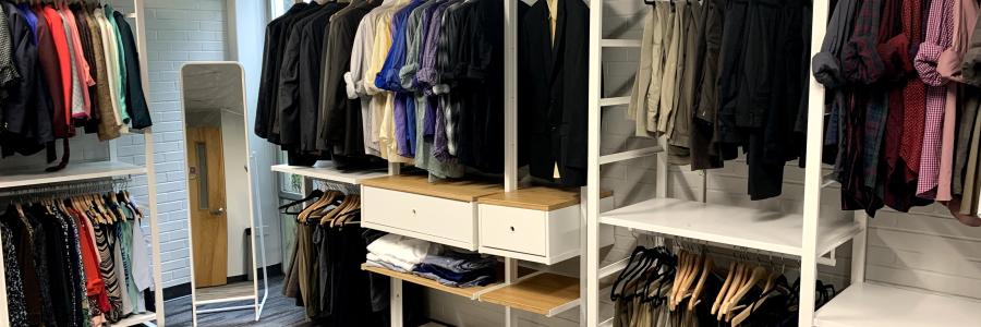 Inside Image of Professional Clothing Closet, showing Clothing Racks along the wall