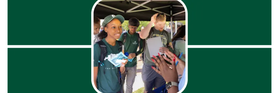 Students speak with recruiters at a networking tabling event