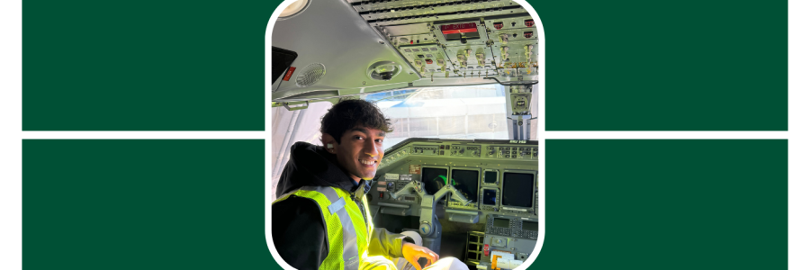 Aavanth poses while sitting in the cockpit of a plane