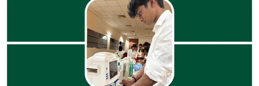Nishal, a student who traveled abroad for a summer internship, is working on some computers at the hospital he interned with.