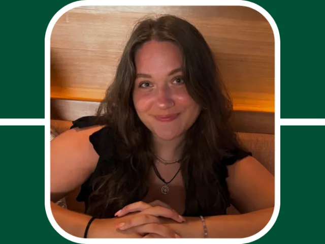 Allie is at the center of a green grid; She is smiling, wears a black shirt, and her arms are folded in front of her.