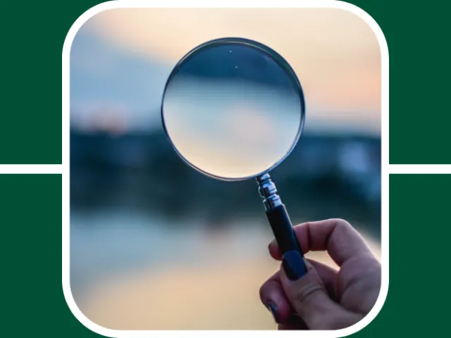 A microscope faces out onto a lake at dusk