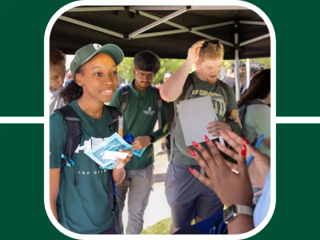 Students speak with recruiters at a networking tabling event