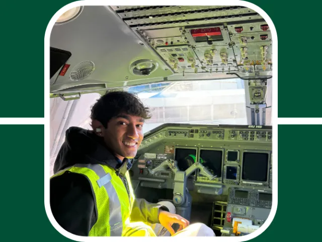 Aavanth poses while sitting in the cockpit of a plane