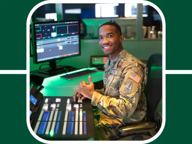 Walter Kirkland poses at a data station in his space force uniform holding up the niner pick axe hand sign