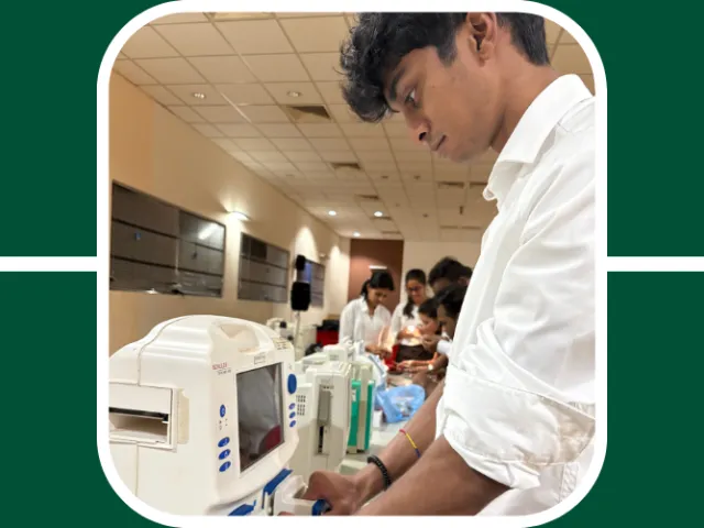 Nishal, a student who traveled abroad for a summer internship, is working on some computers at the hospital he interned with.