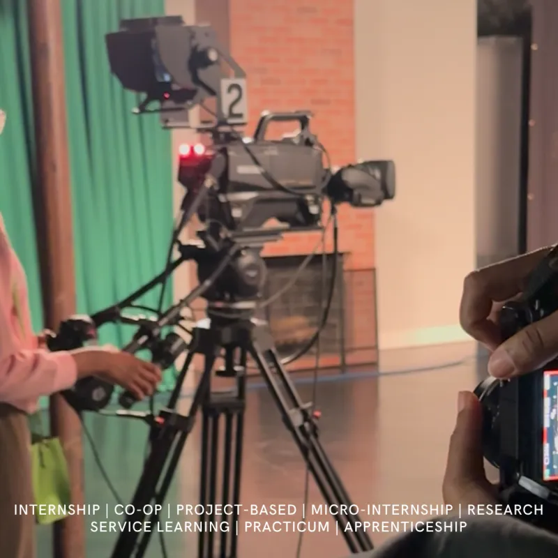 secu summer intern taking photos of students controlling video and audio production at a local studio