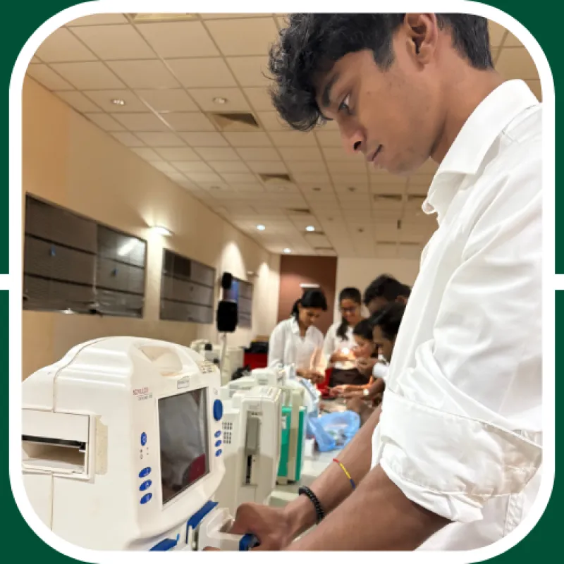 Nishal, a student who traveled abroad for a summer internship, is working on some computers at the hospital he interned with.