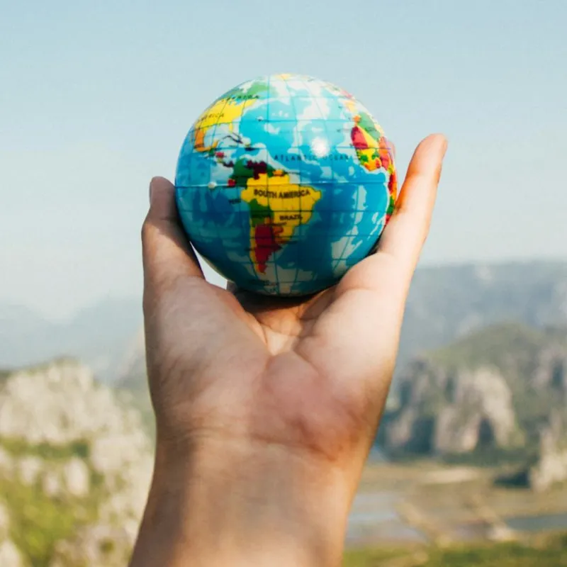 Person holding a small globe