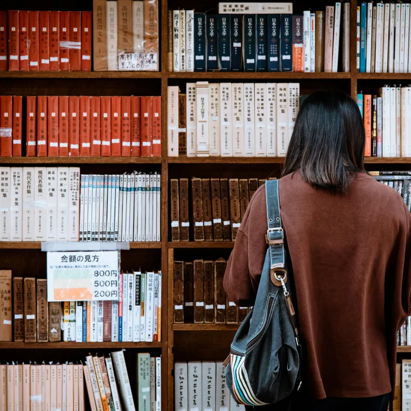 Students standing in front of a bookcase