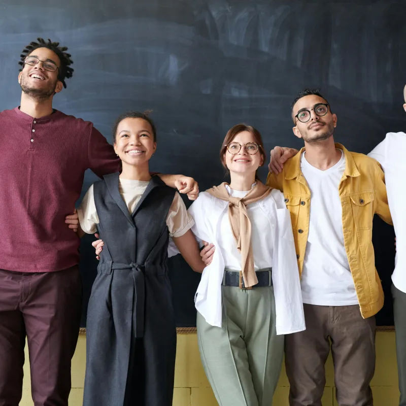 Teachers lined up in front of blackboard