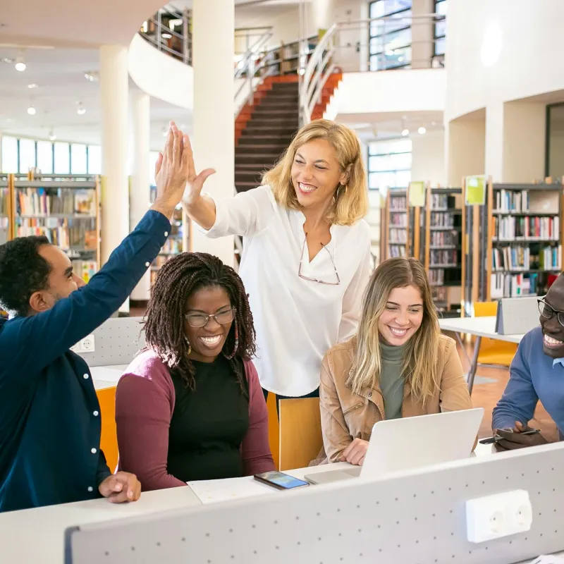 Woman high fiveing a student