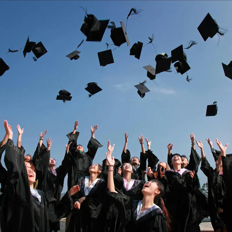 Students throwing their graduation caps in the air