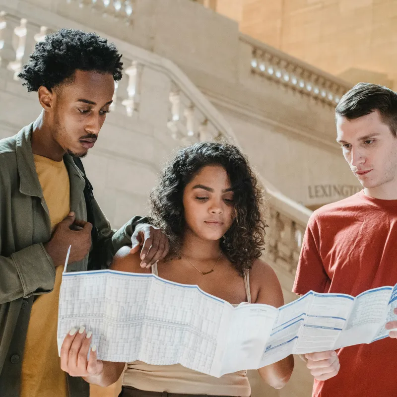 3 students looking at a map