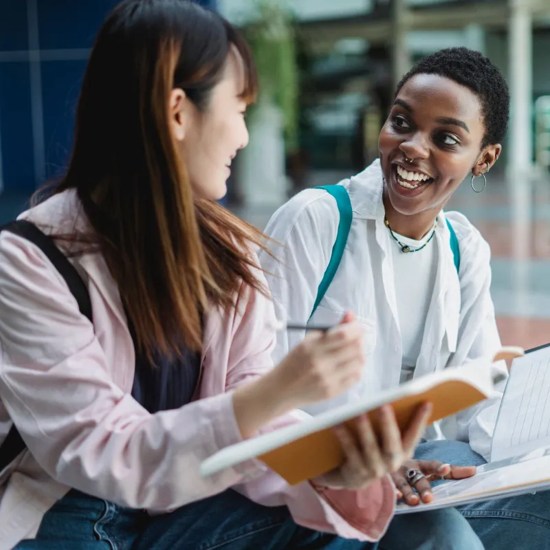 Two girl students talking
